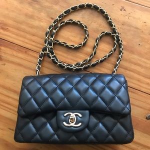 Crossbody lamb skin bag. Red interior with a back pocket.